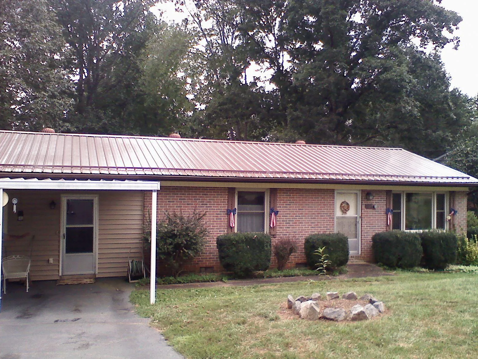 Bronze metal roof and carport on a brick ranch home — Roof Repair work by our crew in Sharon